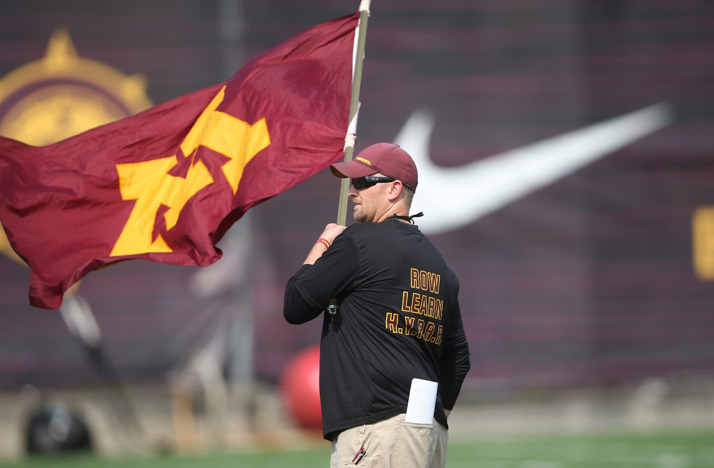 Kyle Gergely equipment manager waved the flag during practice at the University of Minnesota Tuesday August 15, 2017 in Minneapolis, MN. ] JERRY HOLT &#xef; jerry.holt@startribune.com