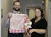 Dr. Erik Bostrom sews and embroiders blankets for every baby he delivers, including Reese Hietalati, held here by mom Lacie.