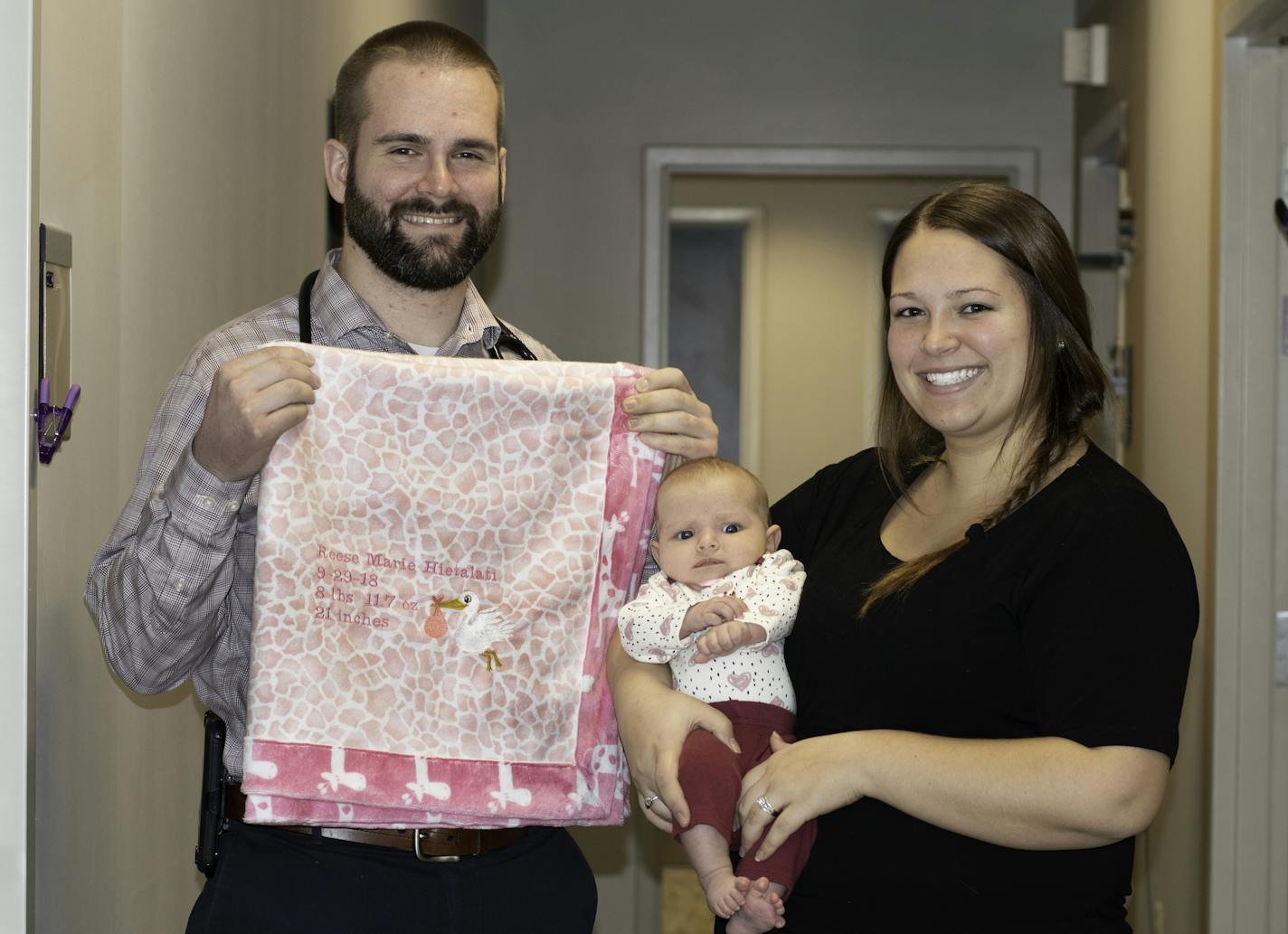 Dr. Erik Bostrom sews and embroiders blankets for every baby he delivers, including Reese Hietalati, held here by mom Lacie.