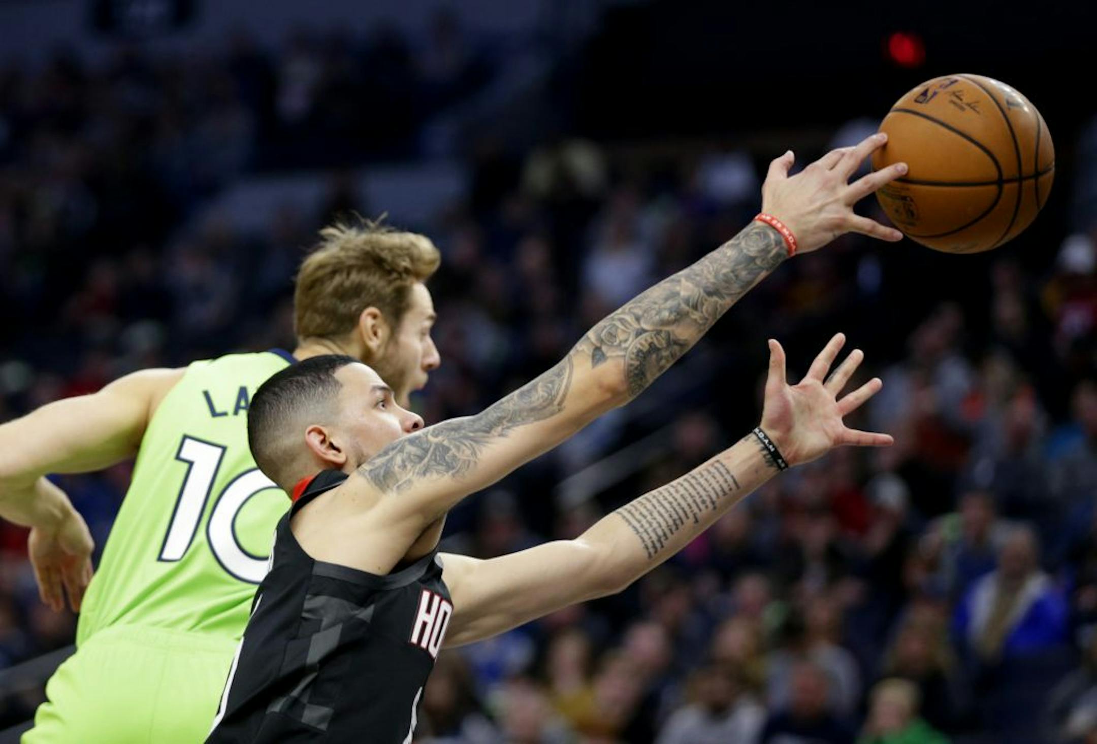 Houston Rockets guard Austin Rivers and Minnesota Timberwolves forward Jake Layman (10) in the first quarter during an NBA basketball game Saturday, Nov. 16, 2019 in Minneapolis.