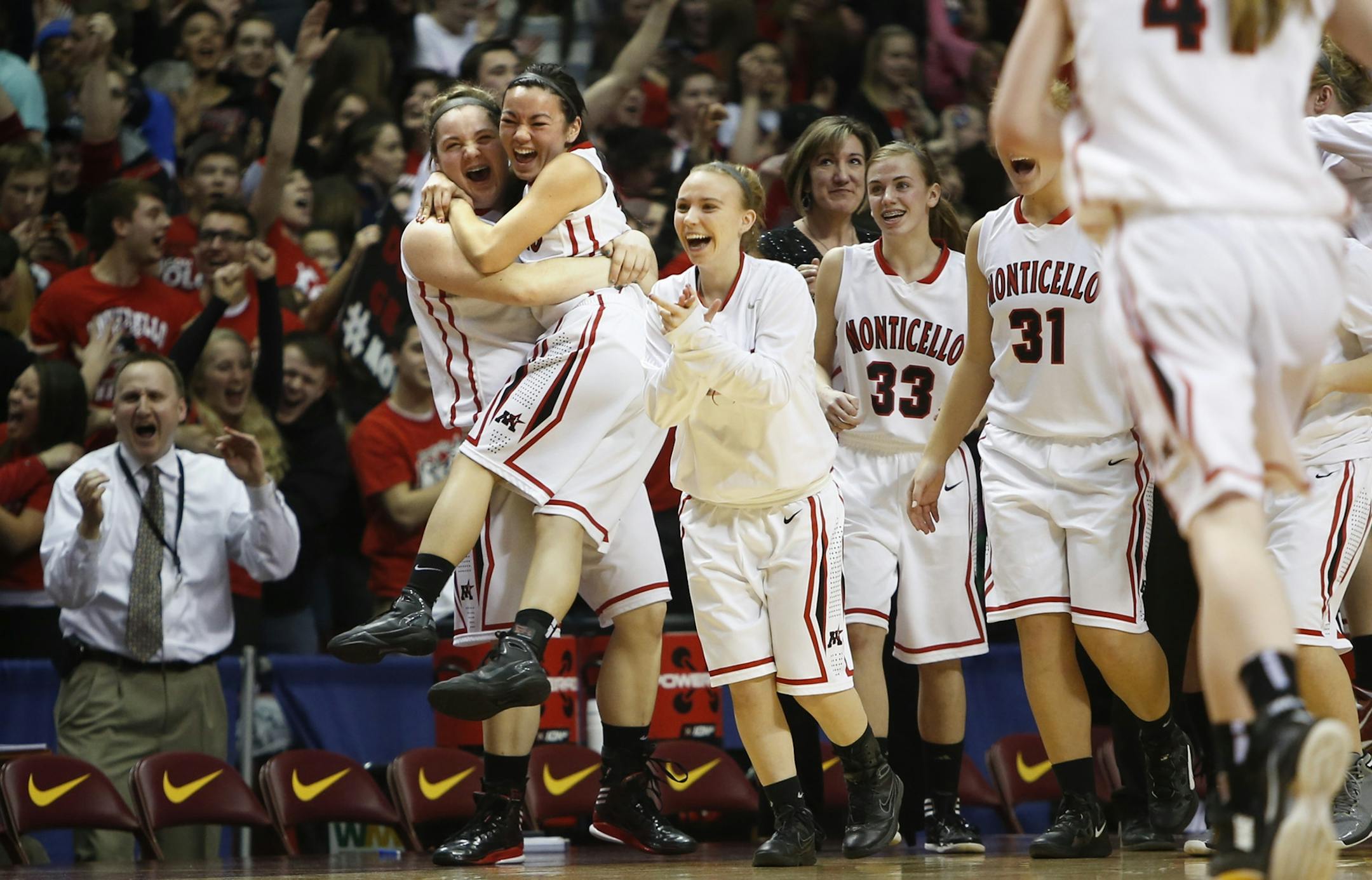 Monticello's Ashlyn Cole picked up teammate Christine Lui as their team celebrated a win against Fergus Falls.