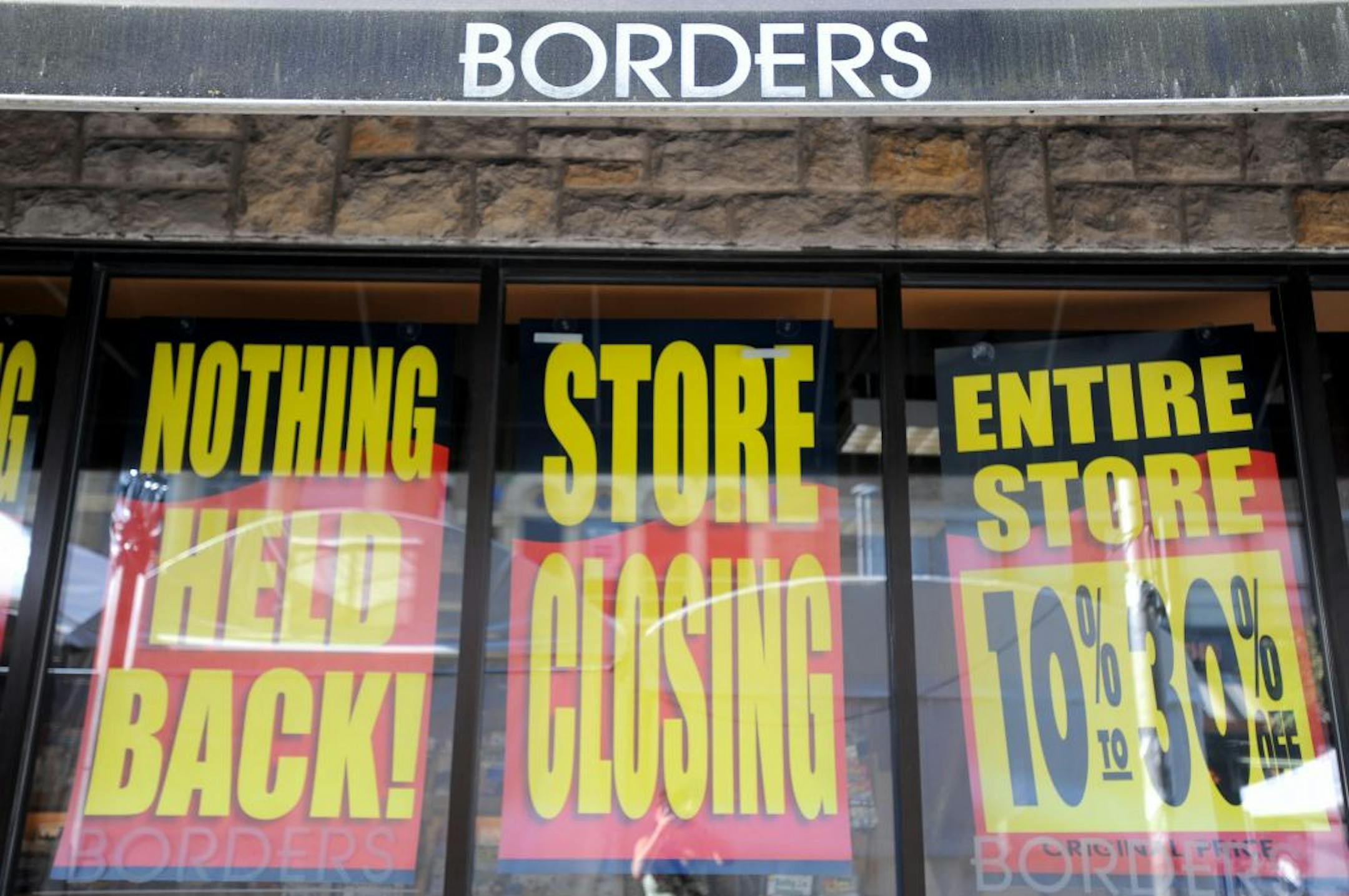Store closing signs are posted on the exterior of the Borders book store in Ann Arbor, Mich., Friday, July 22, 2011. Borders Group began liquidation sales at all of its 399 stores as the 40-year-old chain winds down operations.
