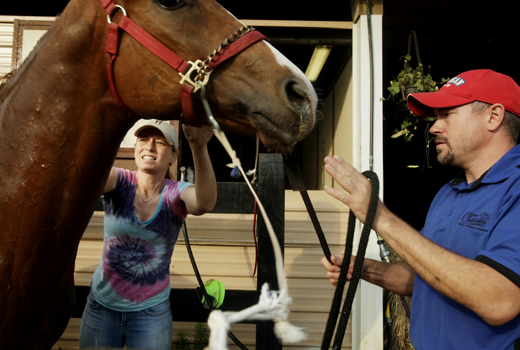Randy Weidner, right, and Lindsay White groomed a horse at Canterbury Park. After they suffered heavy losses in the Moore, Okla., tornado, horsemen from Canterbury and outside stepped up with money, gear and horses to replace losses and keep their stable operating.