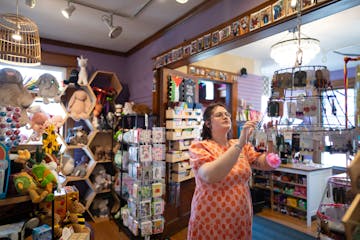 Abigail Adelsheim-Marshall restocked a display of earrings at Mischief Toy Store on April 29, 2025 in St. Paul. The Grand Avenue store in St. Paul has