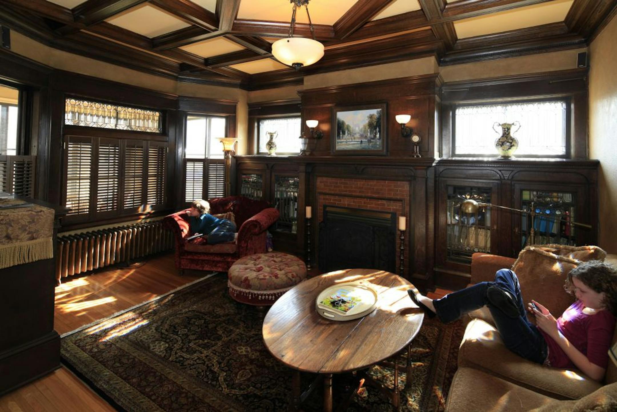 Cole ( 9 years old) and Elise (12 years old) Hannumlounge in the library in their St. Paul home.