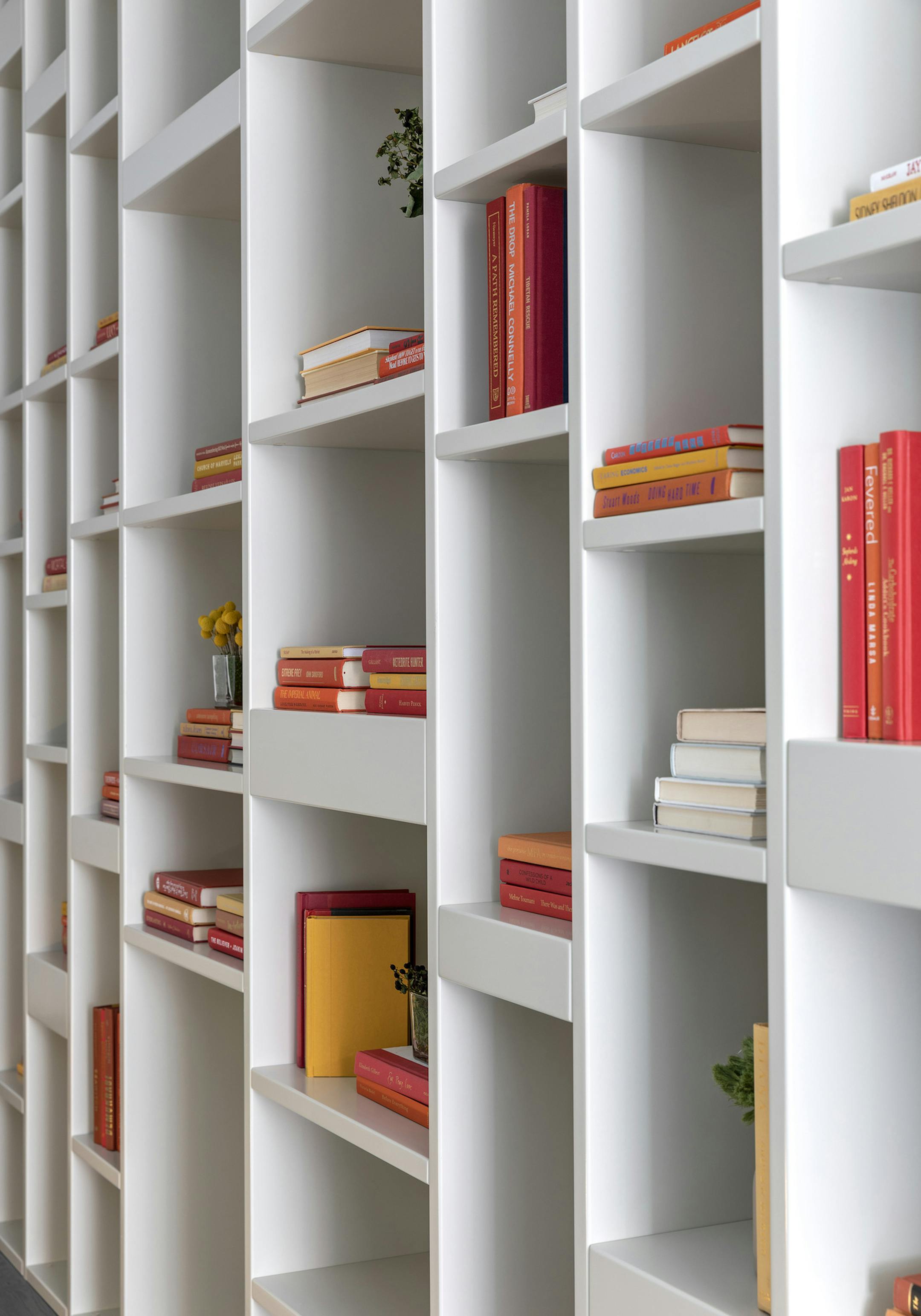 An array of fall colored books helps to add warmth and interest to open shelves. (Design Recipes/TNS)