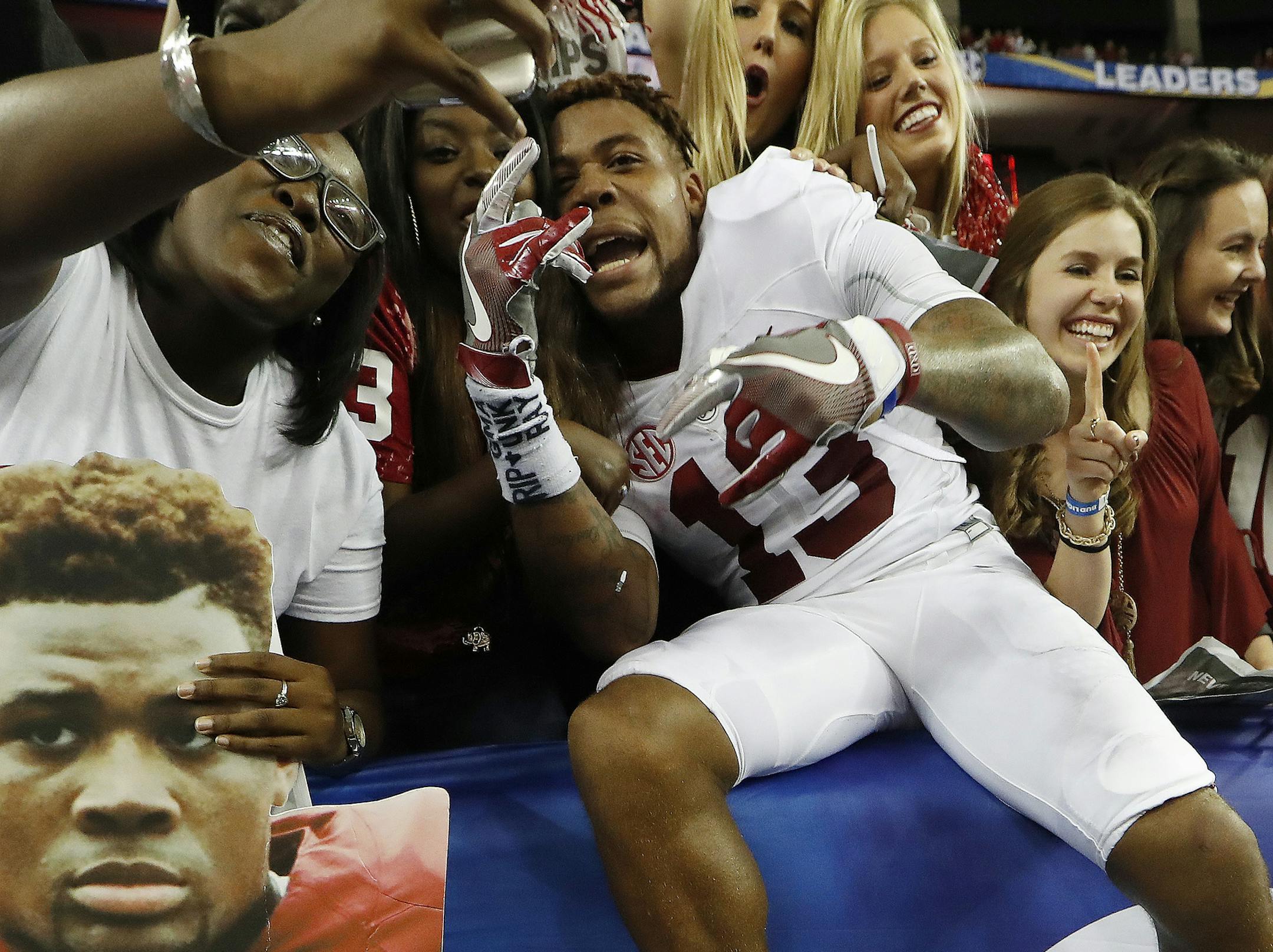 Alabama defensive back Nigel Knott celebrates with fans after the Southeastern Conference championship NCAA college football game against Florida, Saturday, Dec. 3, 2016, in Atlanta. Alabama won 54-16. (AP Photo/John Bazemore)