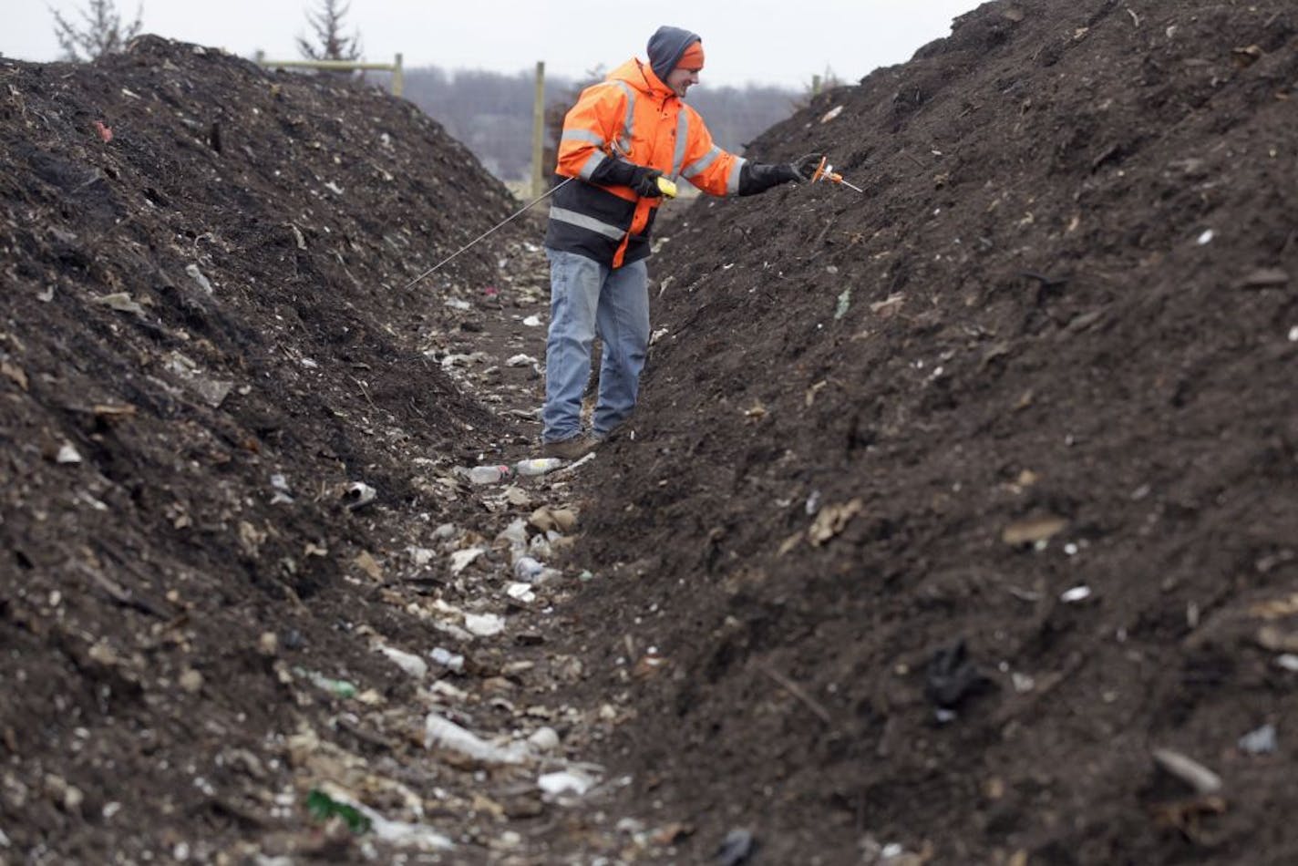 John Volkers checks the temperature of the windrow, one of the steps in the composting process Monday at the Organics Recycling Facility in Prior Lake, MN. The ideal temperature is between 140-160 degrees fahrenheit.