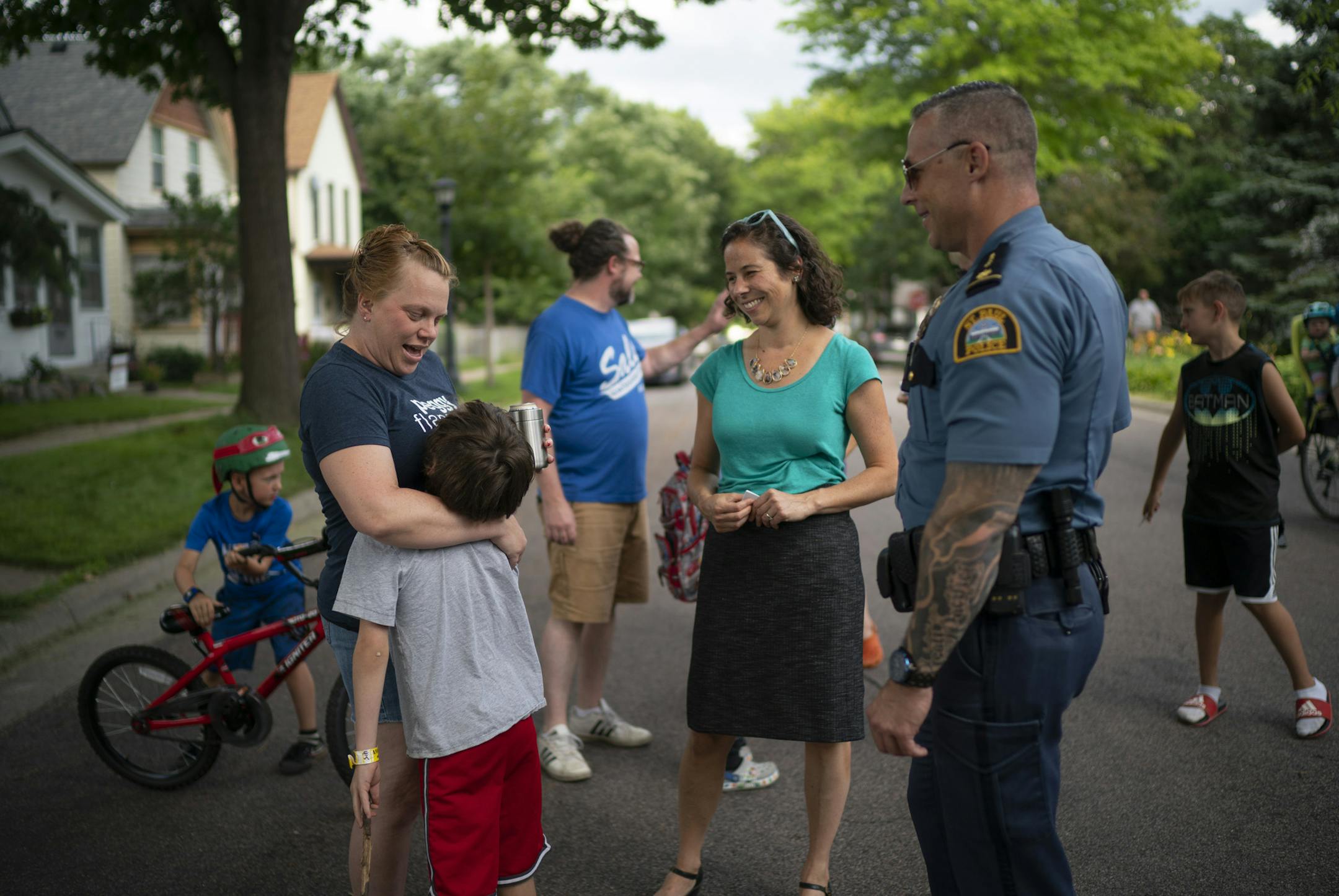 Rebecca Penforl-Murray hugged her son, Peter, while visiting with St. Paul councilmember Rebecca Noecker and St. Paul Police Commander Wes Denning, who both dropped in on their block party on Juno Ave. early Tuesday night. ] JEFF WHEELER • jeff.wheeler@startribune.com St. Paul Mayor Melvin Carter and councilmember Rebecca Noecker dropped in on National Night Out block parties in their city Tuesday evening, August 6, 2019.
