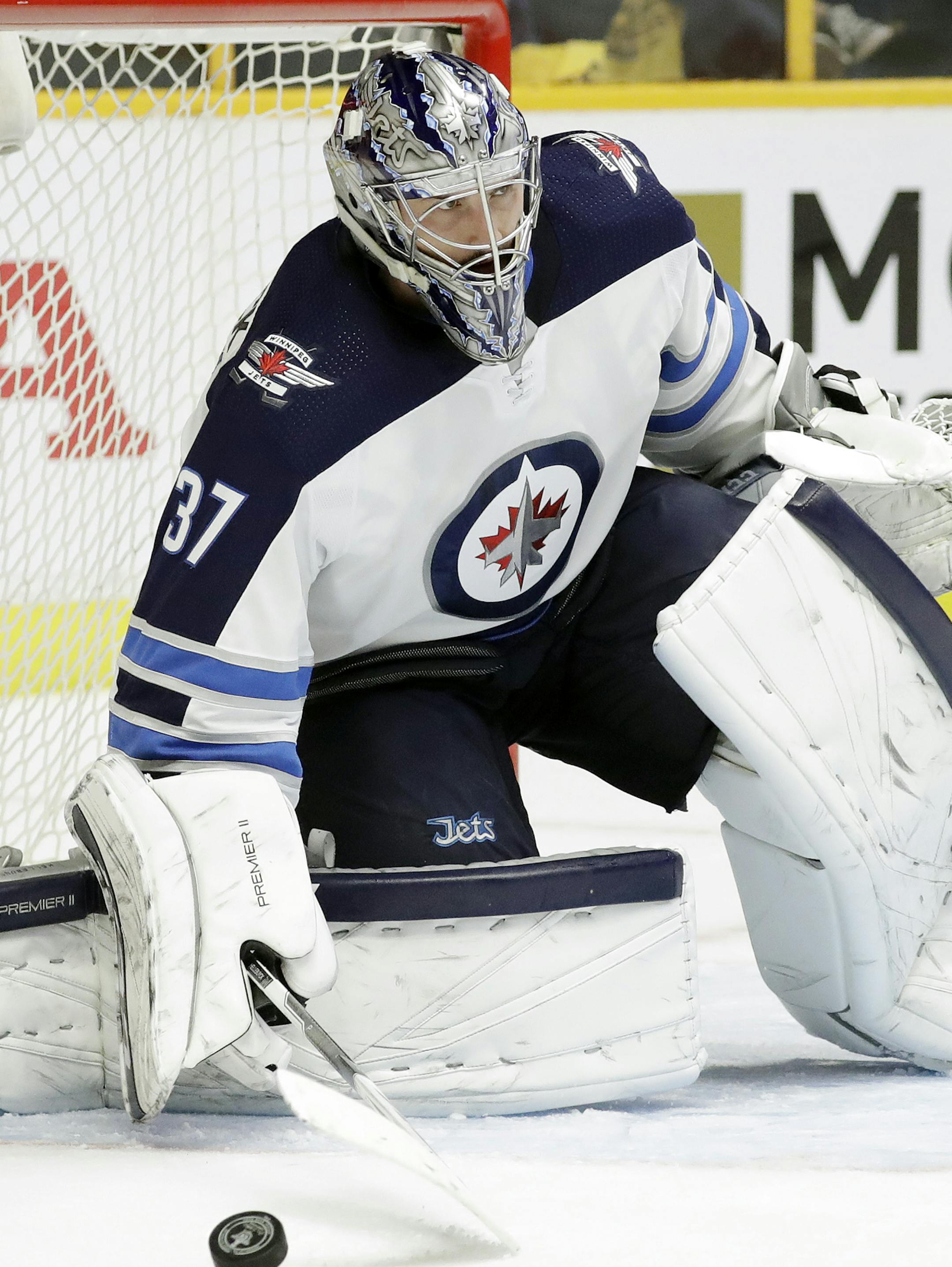 Winnipeg Jets goalie Connor Hellebuyck blocks a shot from the Nashville Predators during the second period in Game 1 of an NHL hockey second-round playoff series Friday, April 27, 2018, in Nashville, Tenn. (AP Photo/Mark Humphrey)