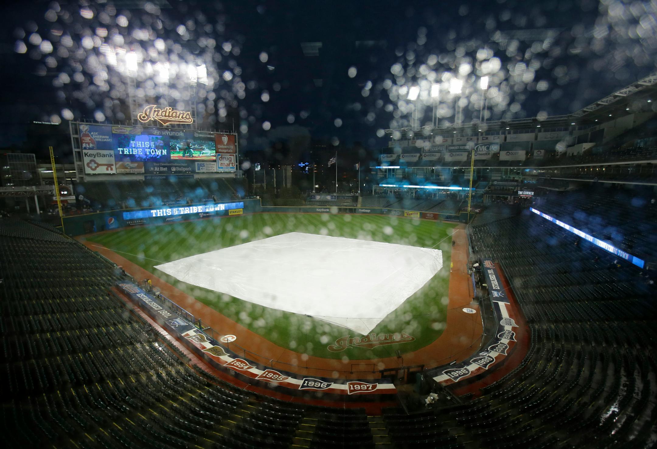 Rain rolls down the glass in the press box during a rain delay in a baseball game between the Twins and Indians on Tuesday in Cleveland. The game was rained out, and the teams will play a doubleheader on Wednesday beginning at 3:10 p.m. Central.