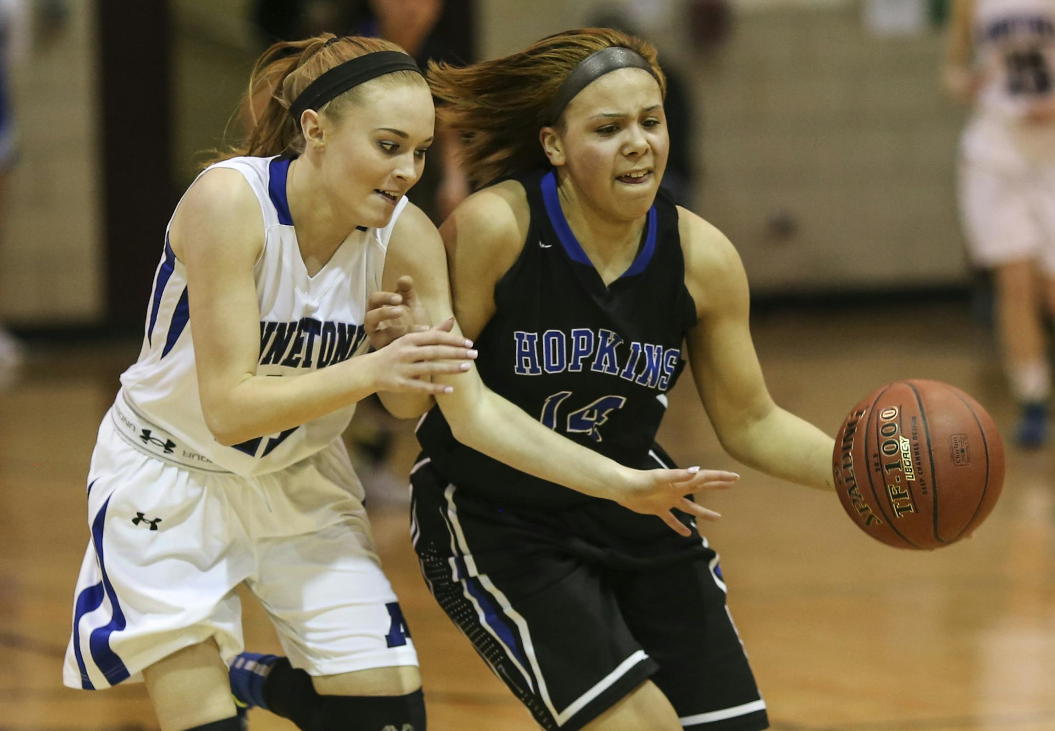 Minnetonka's Cailyn Bade (11) and Hopkins' Ashley Bates (14) chased a loose ball during the first half of the girls basketball section finals at Roosevelt High School in Minneapolis, Minn., on Wednesday, March 11, 2015. ] RENEE JONES SCHNEIDER • reneejones@startribune.com