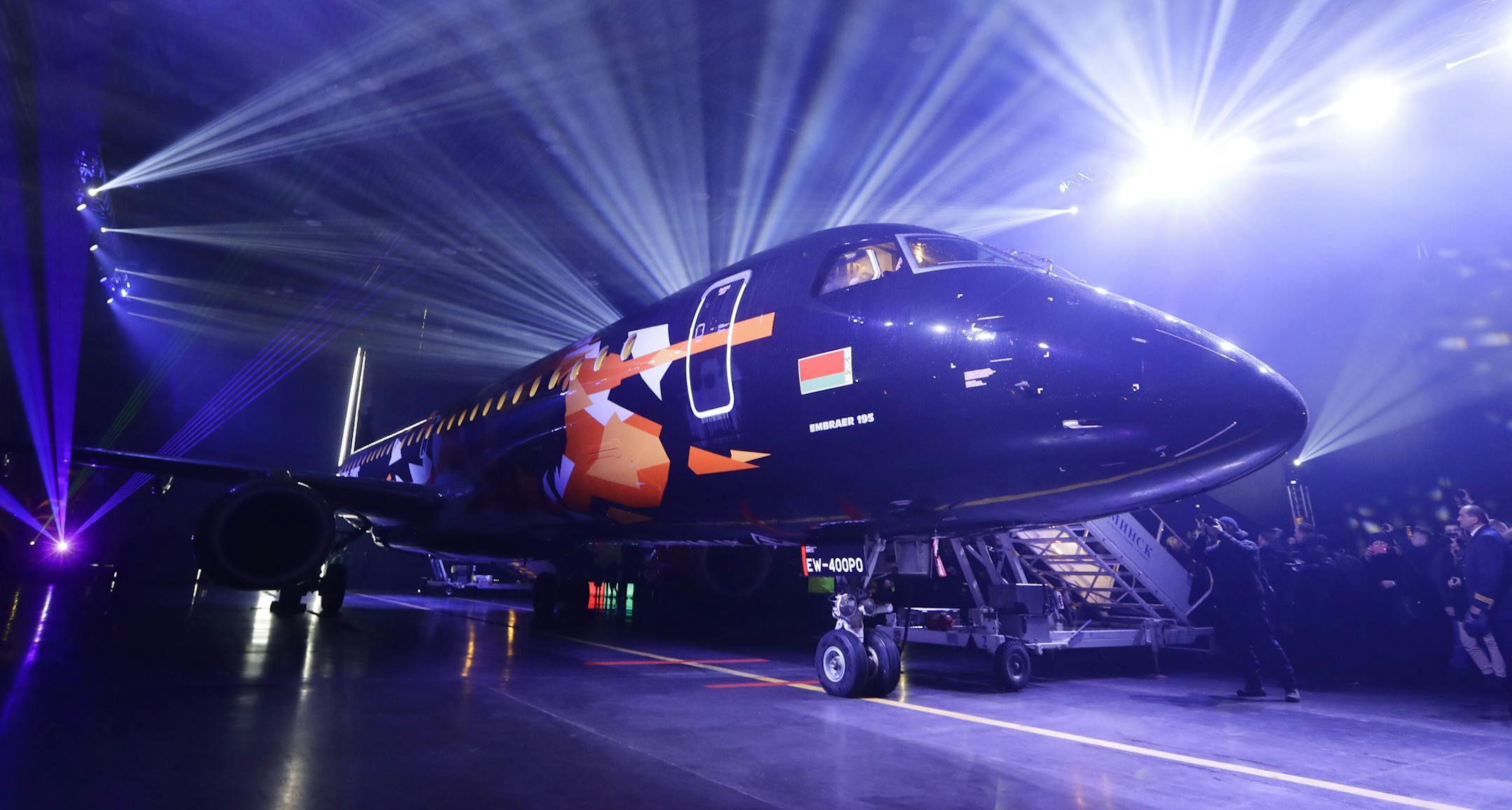 FILE - In this Dec. 12, 2018, file photo, a plane from the Brazilian plane-maker Embraer 195 is displayed by the Belarusian Belavia air company at the national airport in Minsk, Belarus. Boeing is buying a majority stake in Embraer’s commercial aircraft and services operations for $4.2 billion. The joint venture announced Monday, Dec. 17, gives Boeing 80 percent ownership of those operations, with Embraer owning the remaining stake. (AP Photo/Sergei Grits, File)