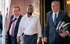 Defendant Said Shafii Farah, center, walks into the U.S. District Court with attorneys Clayton Carlson, left, and Steve Schleicher, right, during the 