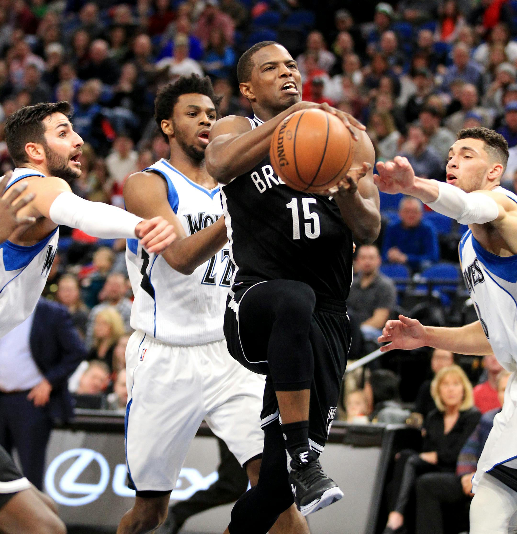 Brooklyn Nets guard Isaiah Whitehead (15) is fouled by Minnesota Timberwolves guard Ricky Rubio (9) with defense from Timberwolves' Andrew Wiggins (22) and Zach Lavine (8) during the first half of an NBA basketball in Minneapolis, Saturday, Jan. 28, 2017.(AP Photo/Andy Clayton-King)