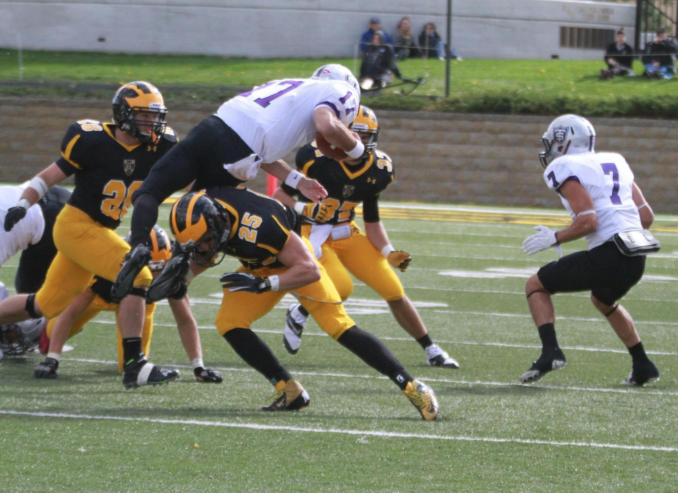 Gustavus vs. St. Thomas in MIAC football on Oct. 12, 2013 at St. Peter, Minn. Gustavus cornerback Zach Dilger (25) saws off St. Thomas runner back John Gould. Photo by Dan Coquyt, Gustavus Adolphus Sports Information