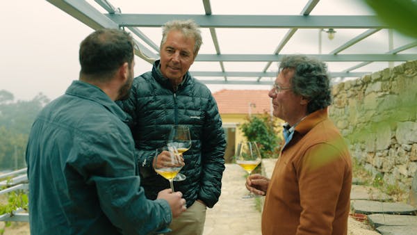Author Dan Buettner, center, Afianes Wines founder Nikos Afianes, right, and his son Konstantinos Afianes drink to their health in Ikaria, Greece, in 
