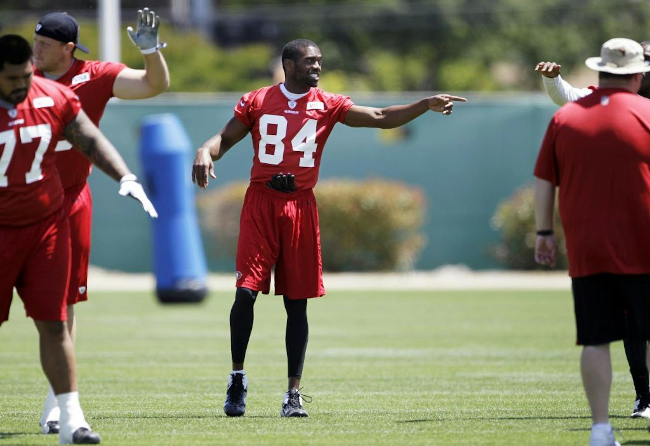 New San Francisco 49ers wide receiver Randy Moss (84) gestures to teammates during NFL football practice at the team's training facility in Santa Clara, Calif., Thursday, May 10, 2012.
