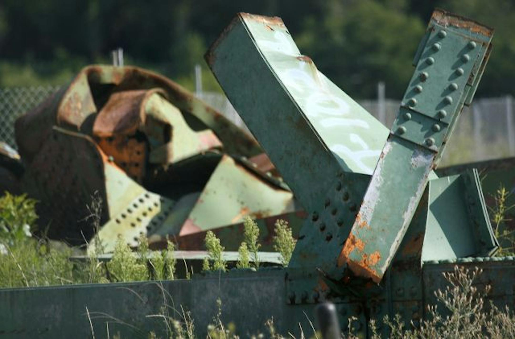 Two years to the day after the I-35W bridge collapse, pieces of twisted metal from the first bridge are visible in Bohemian flats.
