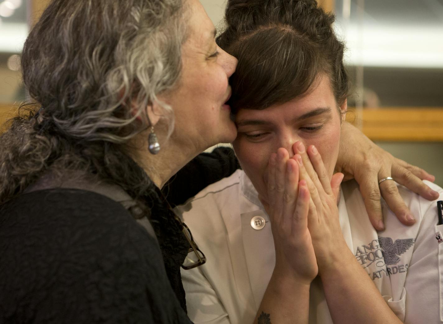 Cynthia Gerdes kisses her daughter, Katy Gerdes, after the Metropolitan Airports Commission approved their restaurant Minnesota Twins Grill and their bakery, Angel Food Bakery, along with Smack Shack, over competitors: Leann Chin, Buffalo Wild Wings and Dunkin' Donuts for a lease in Terminal 1 (Lindbergh) at the Minneapolis-Saint Paul International Airport, Monday, Aug. 17, 2015.] KAYLEE EVERLY kaylee.everly@startribune.com