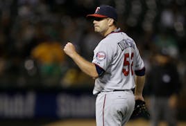 Twins reliever Brian Duensing celebrates the team's July victory at Oakland.