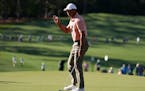 Tiger Woods waves after making a putt on the seventh hole during the first round at the Masters on Thursday.