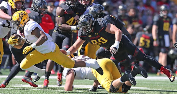 Minnesota's running back Rodney Smith ran with the ball through the Maryland defense.