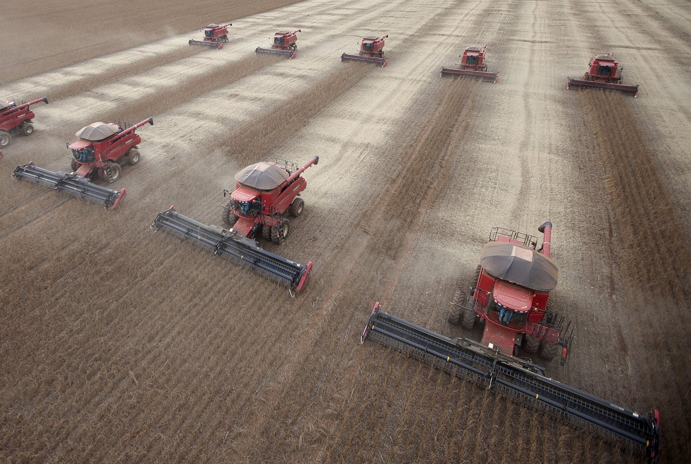 FILE - In this March 27, 2012 file photo, workers use combines to harvest soybeans in Tangara da Serra, State of Mato Grosso, Brazil. For more than a decade, Brazil has been one of the developing world's great hopes, outpacing the growth of Western Europe and the U.S. Many even predicted it would soon become an economic superpower, but now analysts generally believe the big boom is past. Prices for exported commodities such as iron ore and soybeans are drooping due to concerns over Chinese growt