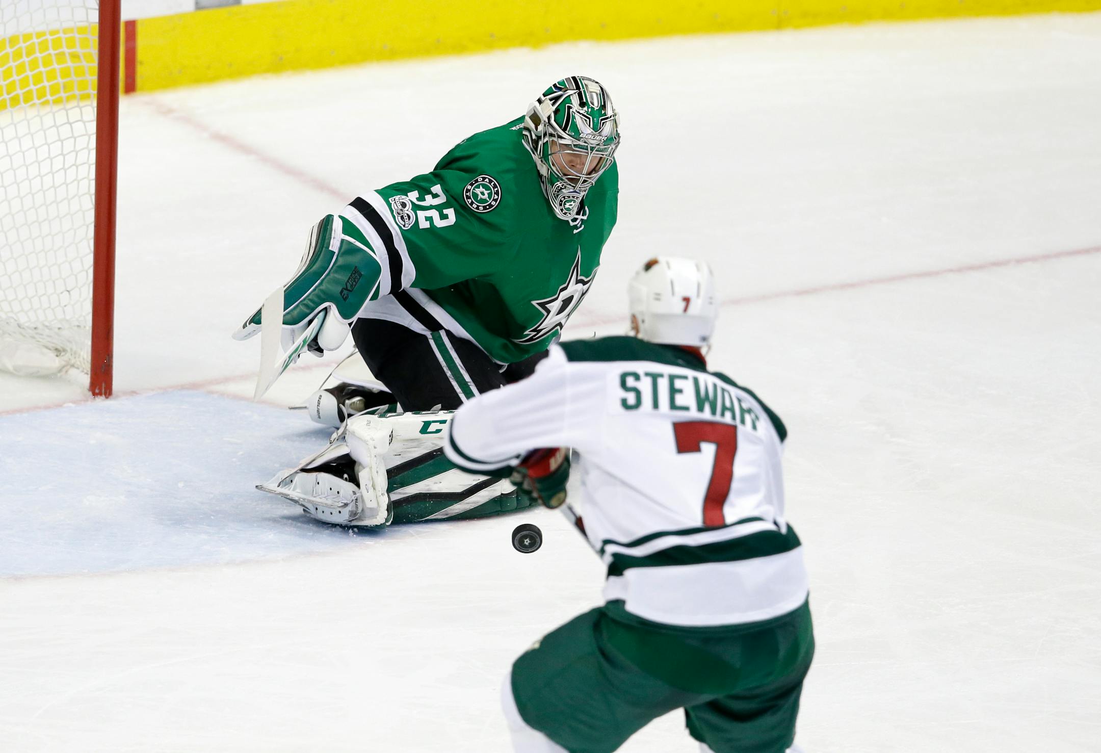 Dallas Stars goalie Kari Lehtonen (32) of Finland defects a shot as Minnesota Wild's Chris Stewart (7) watches in the second period of an NHL hockey game in Dallas, Saturday Jan. 14, 2017. (AP Photo/LM Otero)
