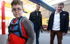 Liam Craig tried on a backpack designed for children on the autism spectrum by University of Minnesota students Will Radke left and Jake Portra March 