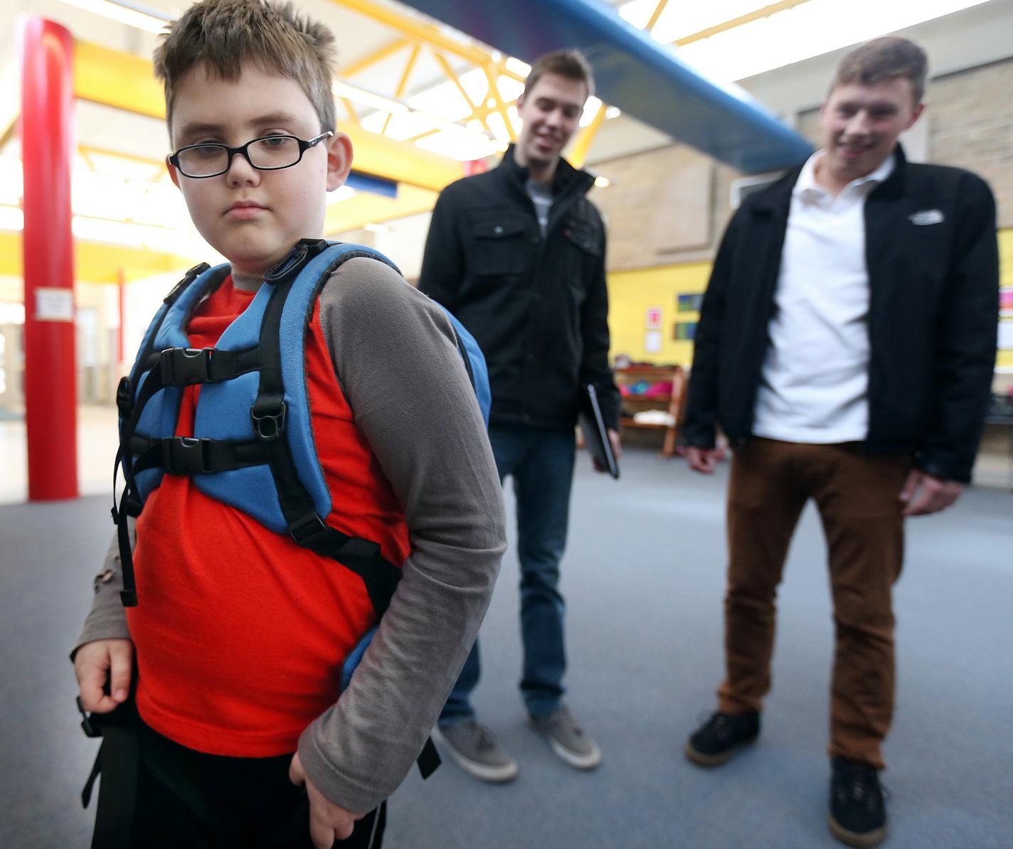 Liam Craig tried on a backpack designed for children on the autism spectrum by University of Minnesota students Will Radke left and Jake Portra March 3, 2016 in Woodbury, MN. ] Jerry Holt/Jerry.Holt@Startribune.com