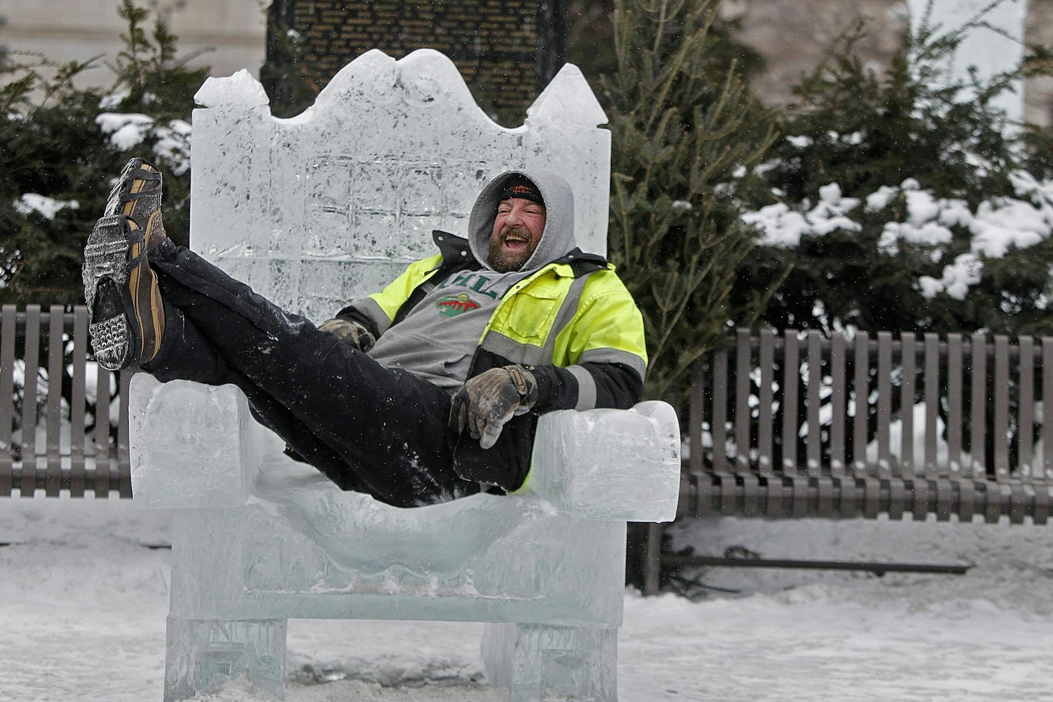 Jeff Lutz, took a few minutes to show how being in the cold weather isn't so bad as he sat on an ice chair at the ice sculpture area in Rice Park in downtown St. Paul, MN, Thursday, January 31, 2013. Lutz, who loves ice fishing, said the key to staying warm is dressing in layers and embracing the Minnesota outdoors. (ELIZABETH FLORES/STAR TRIBUNE) ELIZABETH FLORES � eflores@startribune.com