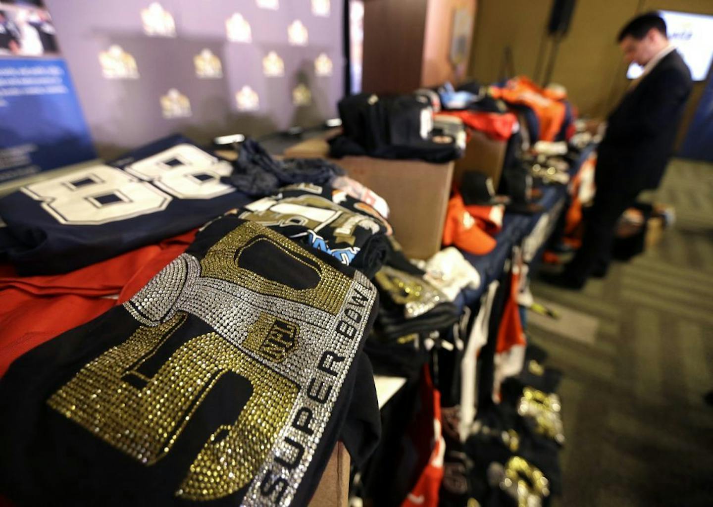 Counterfeit Super Bowl and NFL merchandise confiscated by U.S. Immigration and Customs Enforcement officials is displayed before a news conference Thursday, Feb. 4, 2016, in San Francisco.