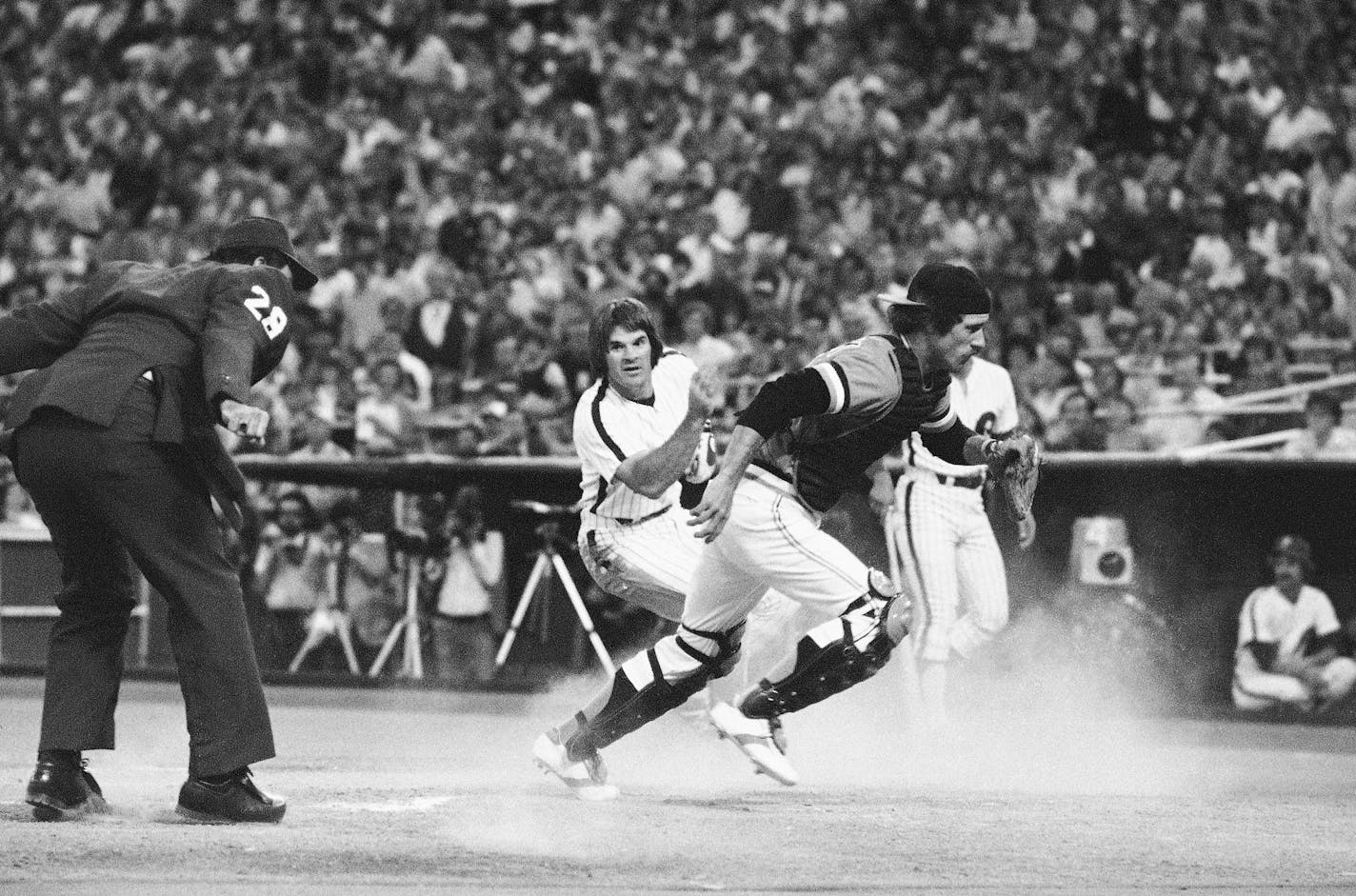 FILE - In this July 1979 file photo, Philadelphia Phillies' Pete Rose turns as he crosses the plate to watch San Francisco Giants catcher Mike Sadek chase down the ball that went by him in the first inning of a baseball game in Philadelphia. Rose had scored from second base on a teammate's single. Sadek, a popular backup catcher who played all eight of his major league seasons with the Giants, has died. He was 74. The team announced Sadek died Wednesday, Jan. 20, 2021, in San Andreas, Calif., following a short illness. (AP Photo/Rusty Kennedy, File)