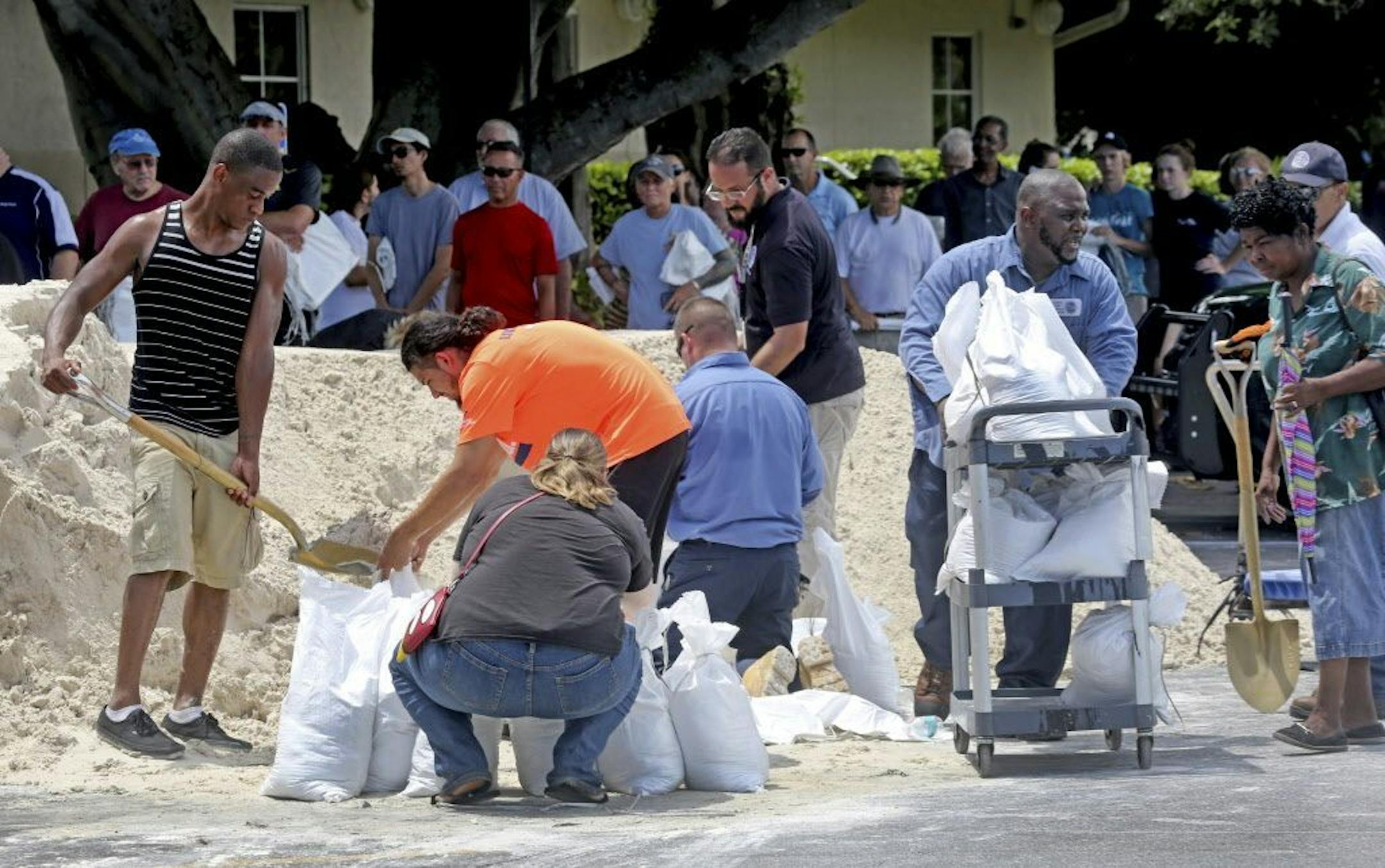 Residents line up at Frost Park in Dania Beach, Fla., and fill up sandbags in preparation of Hurricane Irma in Dania Beach, Fla., on Thursday, Sept. 7, 2017. Irma cut a path of devastation across the northern Caribbean, leaving thousands homeless after destroying buildings and uprooting trees on a track Thursday that could lead to a catastrophic strike on Florida.
