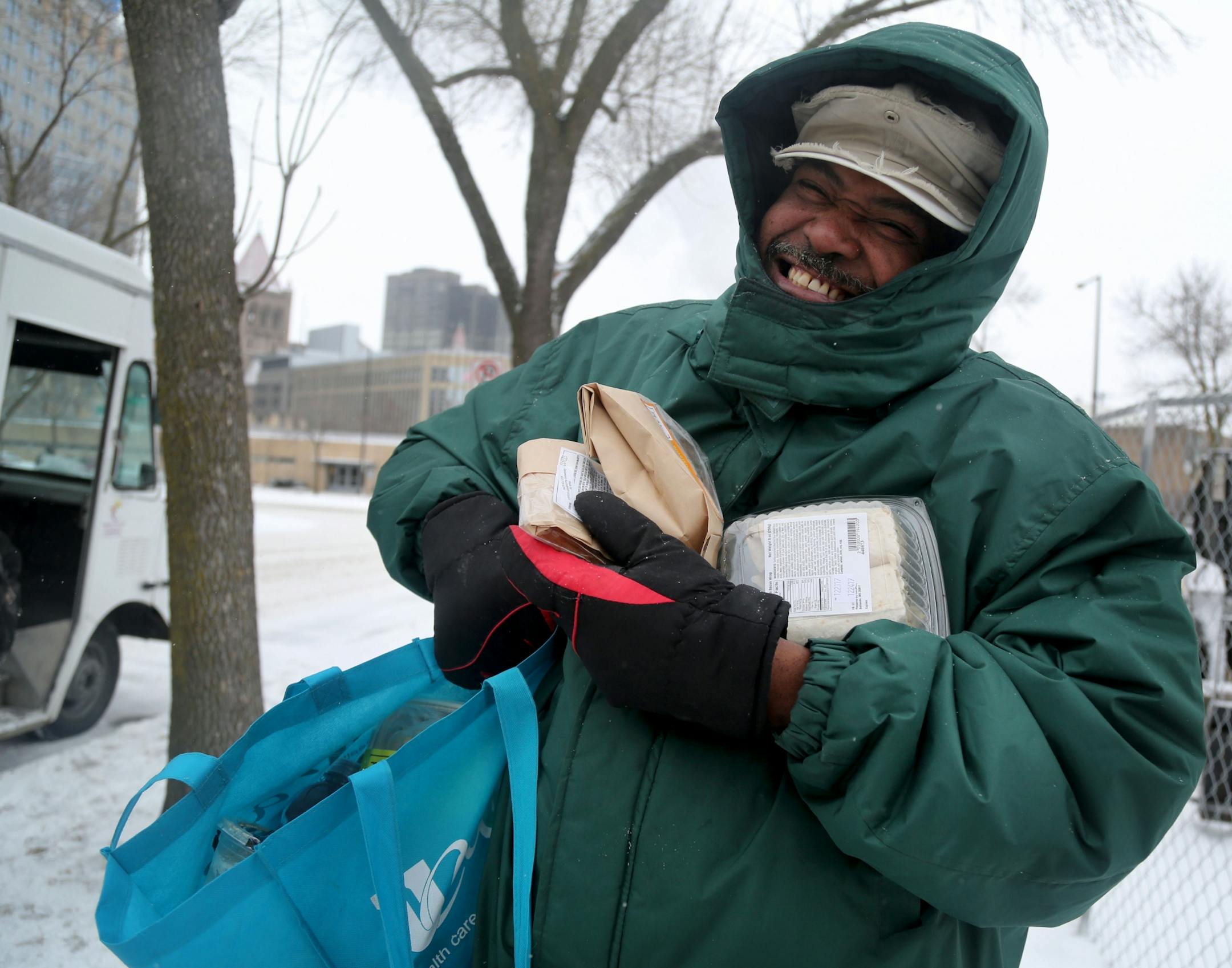 The local non-profit, Loaves and Fishes has partnered with the MSP Airport and concessionaire HMS Host to donate ready-to-eat meals not purchased at the airport, that would otherwise be thrown away, to the homeless near the Dorothy Day Center Thursday, Dec. 28, in St. Paul, MN. Here, Odell, who wanted only his first name used, was happy to have received sandwiches, fruit and other food that will get him and his girlfriend through the next few days.