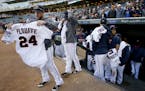 Trevor Plouffe (24) and Twins teammates lined up to give away their jerseys at the end of the game.