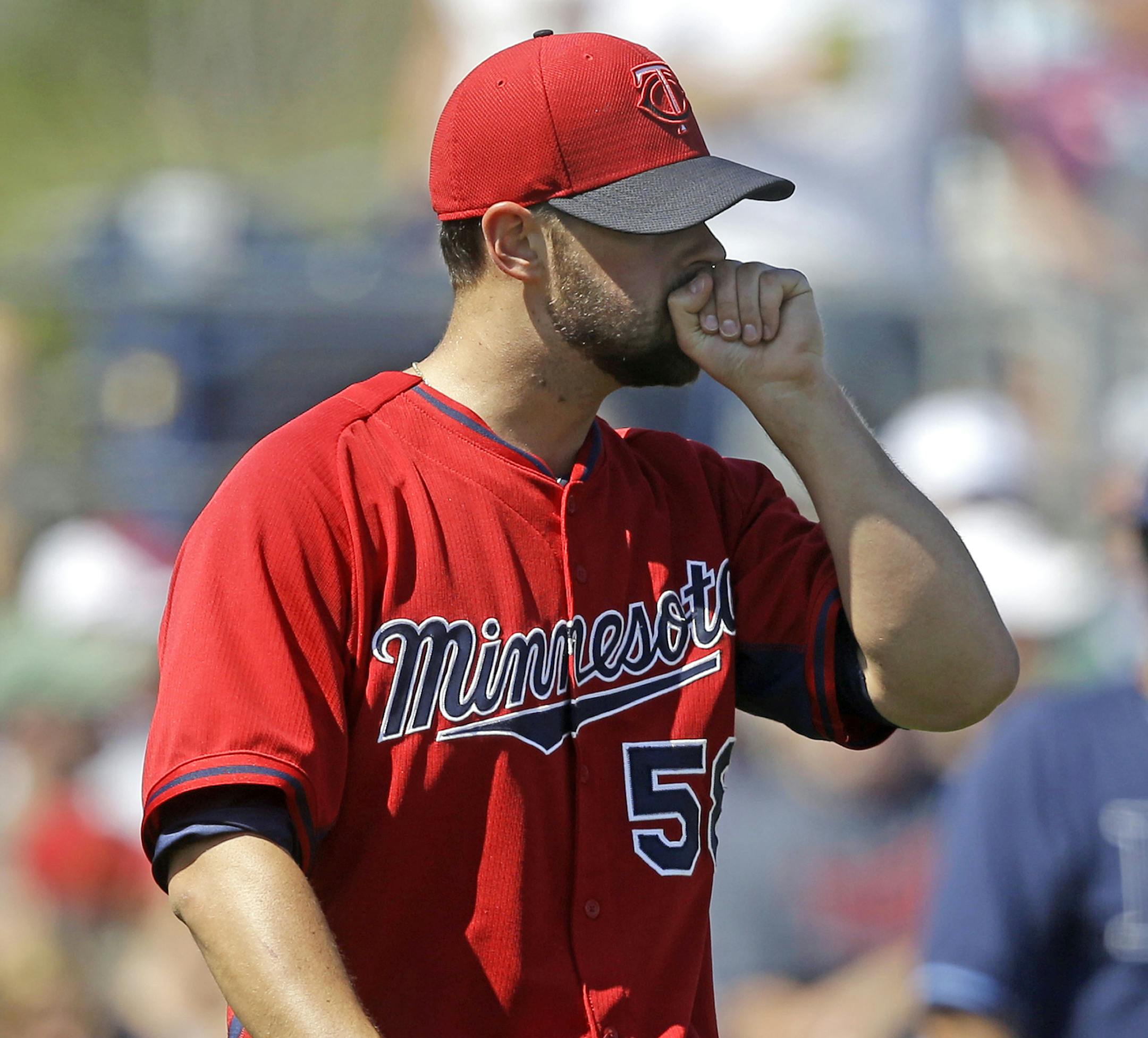 Minnesota Twins pitcher Scott Diamond walks on the mound in the sixth inning an exhibition baseball game against the Tampa Bay Rays in Port Charlotte, Fla., Tuesday, March 11, 2014. The Rays won 7-1. (AP Photo/Gerald Herbert)