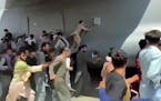 Thousands of Afghans rushed onto the tarmac at the airport in Kabul on Monday, some so desperate to escape the Taliban capture of their country that t