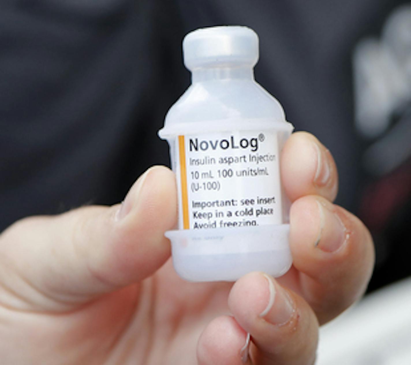 A patient holds a vial of insulin during a news conference outside the Olde Walkersville Pharmacy, Sunday, July 28, 2019, in Windsor, Ont. Democratic presidential candidate, Sen. Bernie Sanders, I-Vt., and a busload of insulin patients stopped in Windsor to purchase the drug to highlight the high costs of the insulin in the United States. (AP Photo/Carlos Osorio)