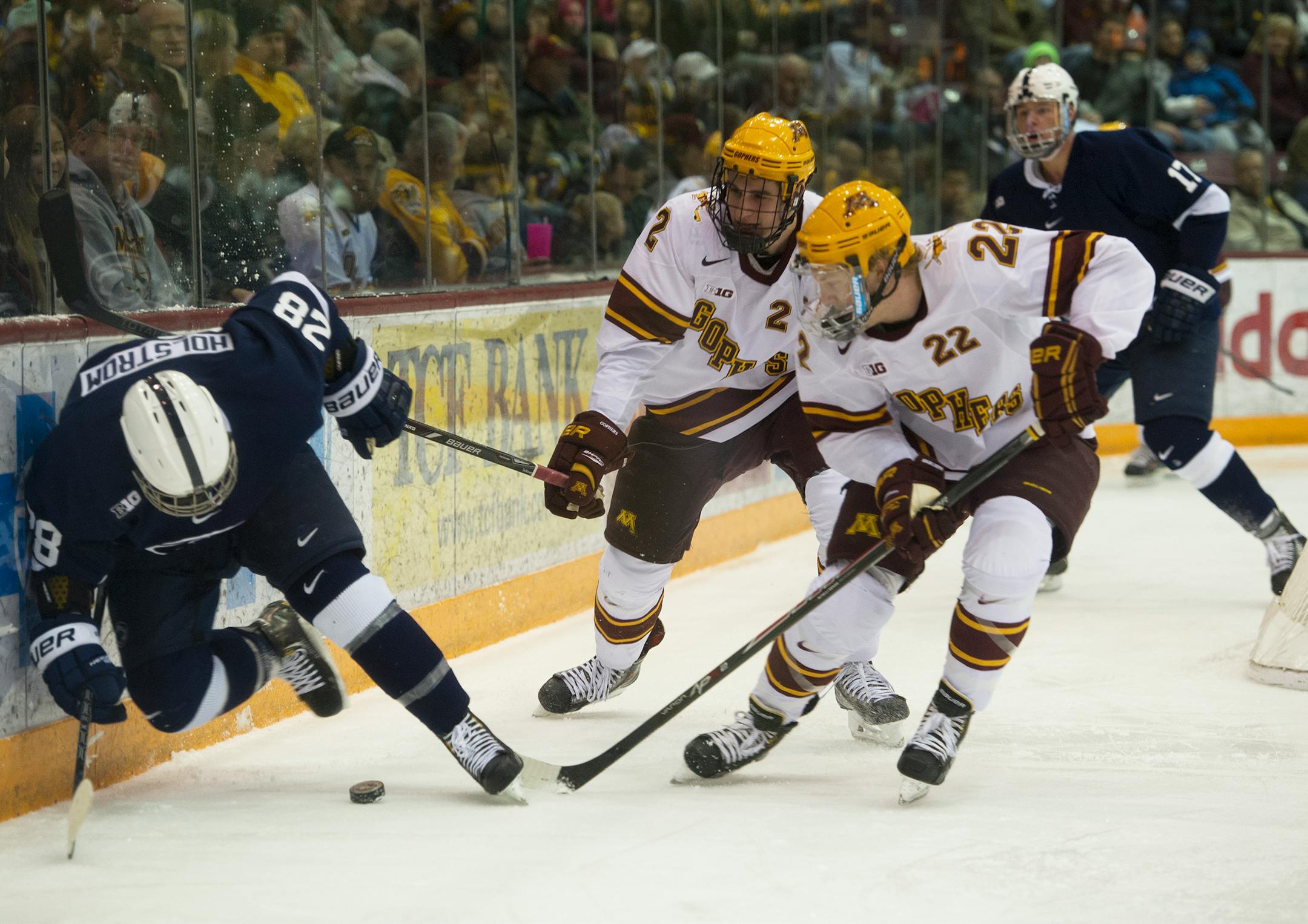 Minnesota's Travis Boyd, and Brady Skjel strip the puck from Penn State's Taylor Holstrom during the first period of a game at Mariucci Arena this season.