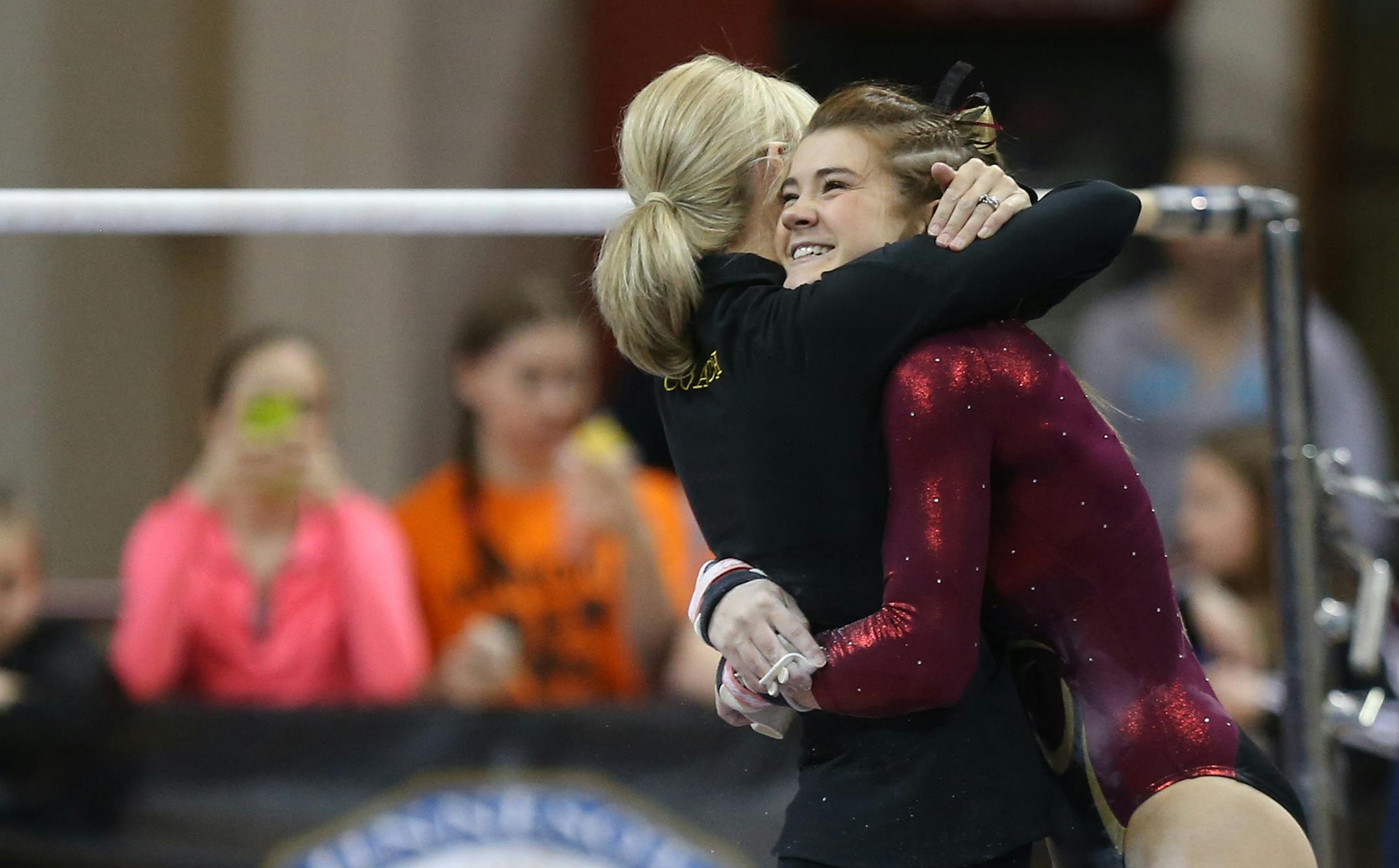 Northfield's Bailey DuPay got a hug from her coach after performing on the uneven bars during the Class 2A gymnastics state meet at the Sport Pavilion in Minneapolis Saturday, February 22, 2014 ] (KYNDELL HARKNESS/STAR TRIBUNE) kyndell.harkness@startribune.com