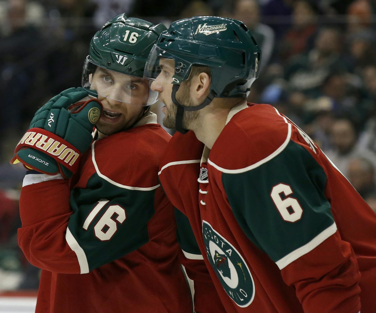 Minnesota Wild left wing Jason Zucker (16) talks with defenseman Marco Scandella (6) during the second period of an NHL hockey game against the Buffalo Sabres in St. Paul, Minn., Tuesday, Jan. 12, 2016. (AP Photo/Ann Heisenfelt) ORG XMIT: OTKAH104