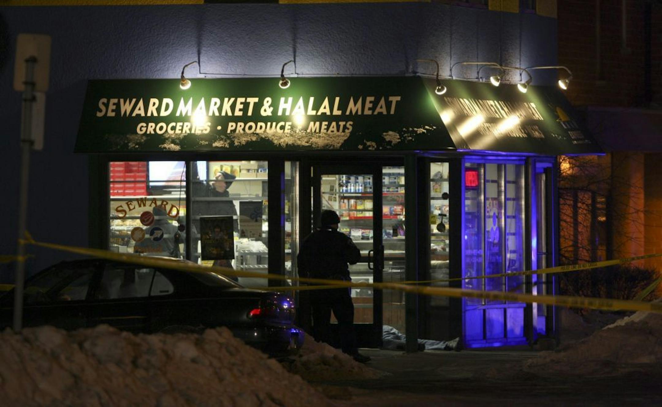 Police investigators examined the interior of the Seward Market after three people were shot and killed there in 2010.