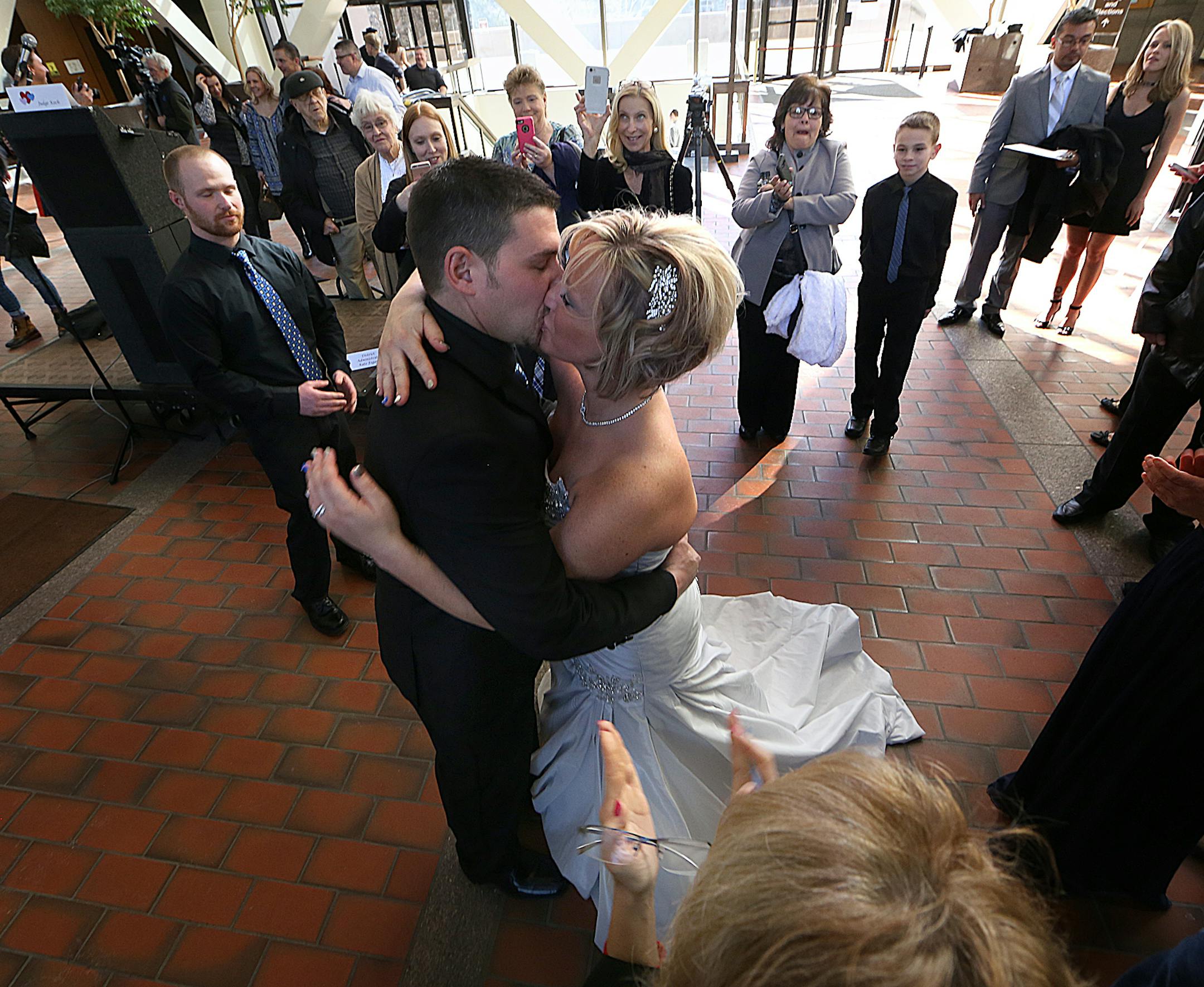 Newlyweds Matt Parker and Stephanie (Cress) Parker kissed during their wedding ceremony. ] JIM GEHRZ ï james.gehrz@startribune.com / Minneapolis, MN / February 12, 2016 /12:00 PM ñ BACKGROUND INFORMATION : Fourth Judicial District judges will unite 34 couples in matrimony at no charge on Friday, February 12, 2016. More than 100 couples have been united at the Valentineís Day weekend annual event. A quartet, Musica Ipsa Loquitor, featuring the Honorable Elizabeth Cutter will play t