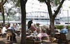 The popular, tree-shaded patio at the Dock Cafe in Stillwater gives diners an up-close-and-personal view of the St. Croix River.