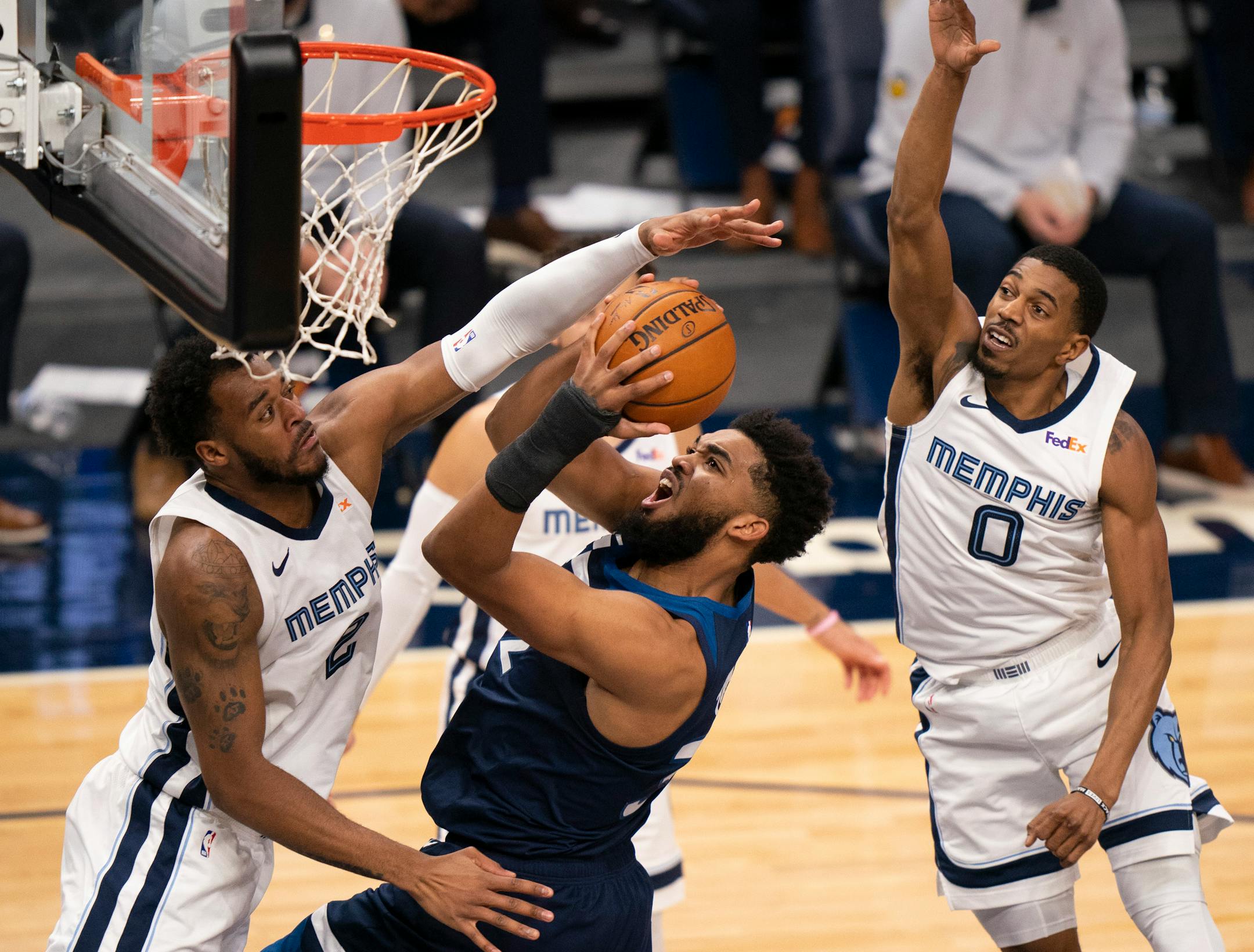 Timberwolves center Karl-Anthony Towns put up a second quarter shot while defended by Memphis' Xavier Tillman (2) and De'Anthony Melton