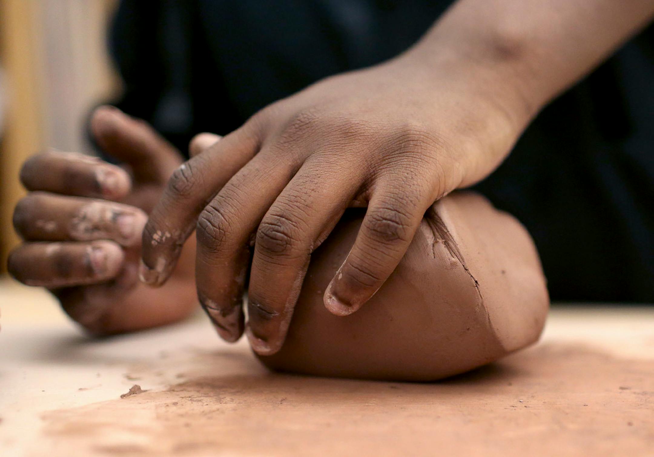 Edison High 10th grader Jasean Maxey, wedges clay to get air bubble out to be used to throw a bowls for the Empty Bowls fundraiser at Edison High School Thursday, April 13, 2017, in Minneapolis, MN.