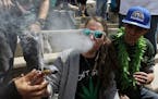 Partygoers listen to music and smoke marijuana on one of several days of the annual 4/20 marijuana festival, in Denver's downtown Civic Center Park, S