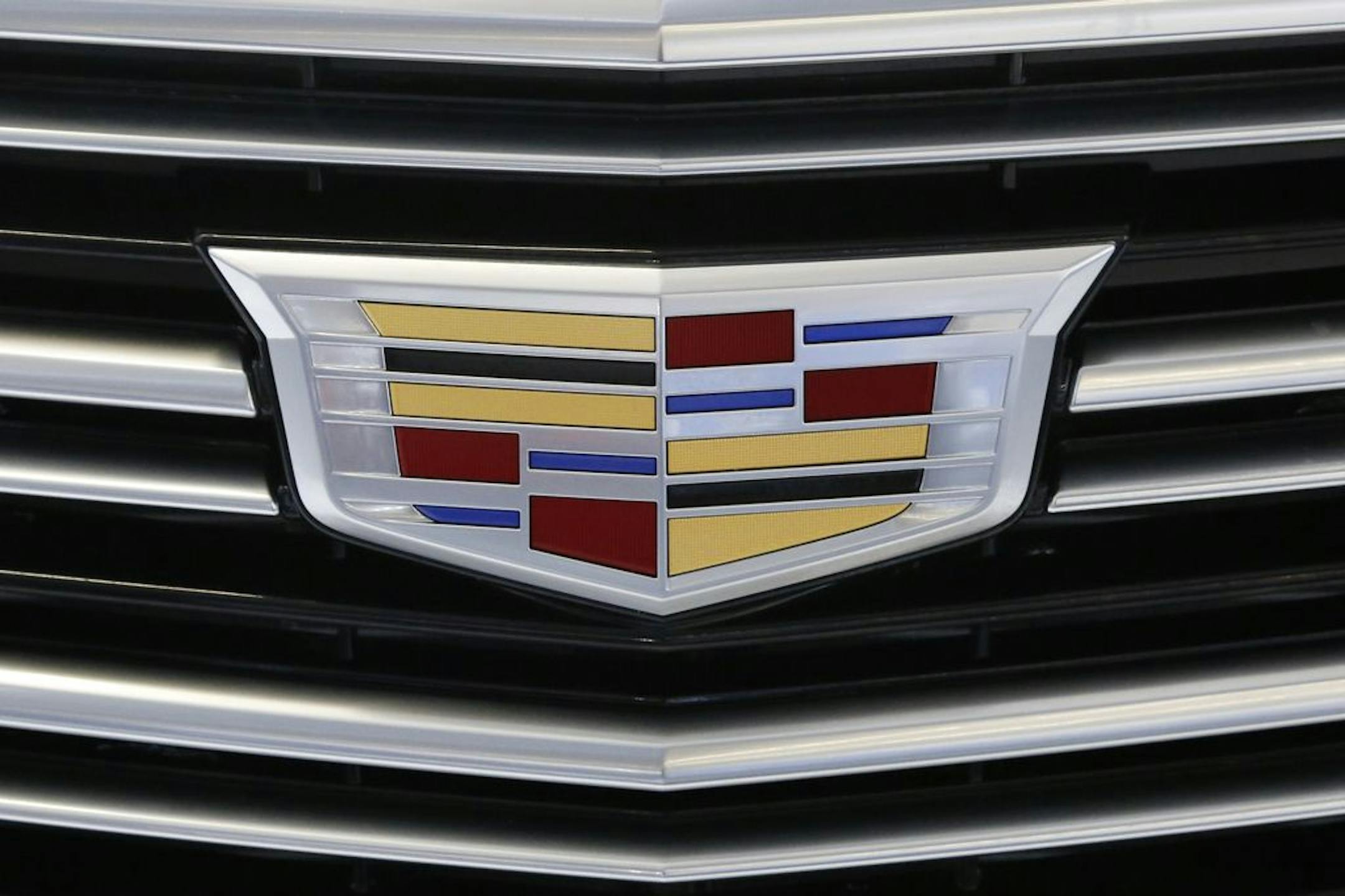 FILE - This Thursday, Feb. 11, 2016, file photo shows the Cadillac logo, a General Motors Co. brand, on display on a vehicle at the Pittsburgh International Auto Show in Pittsburgh. The U.S. government's road safety agency on Wednesday, Nov. 11, 2020, is investigating complaints that the rear suspensions on older Cadillac SUVs can fail, causing drivers to lose control and possibly crash. The probe by the National Highway Traffic Safety Administration covers about 344,000 SUVs from 2010 through 2